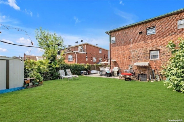 view of yard featuring a shed and a patio area