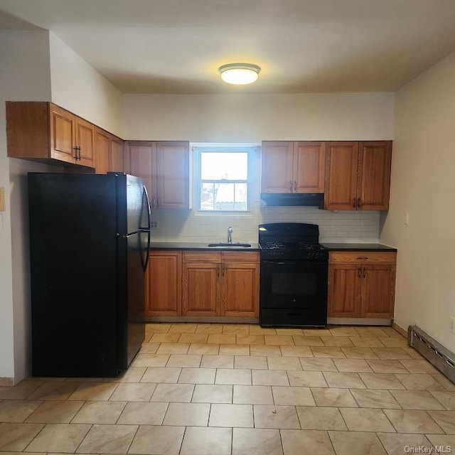 kitchen with backsplash, a baseboard heating unit, sink, and black appliances