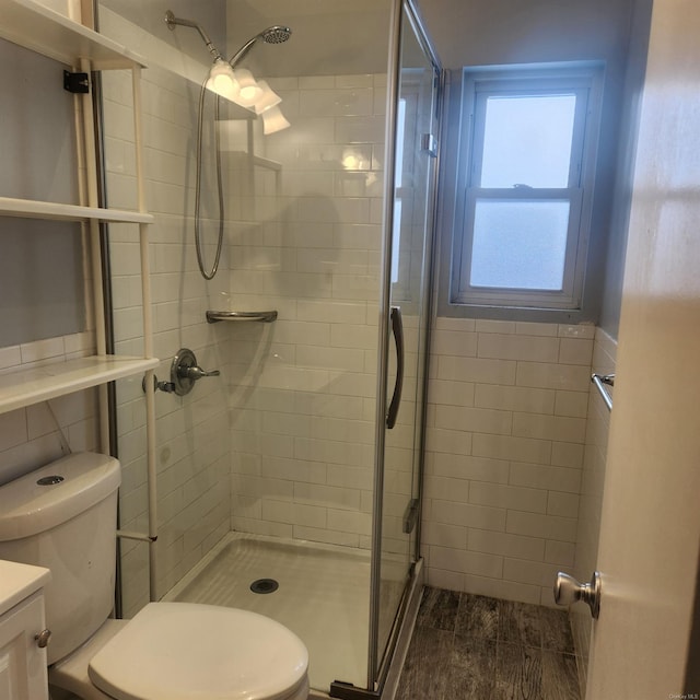 bathroom with walk in shower, vanity, toilet, and tile walls