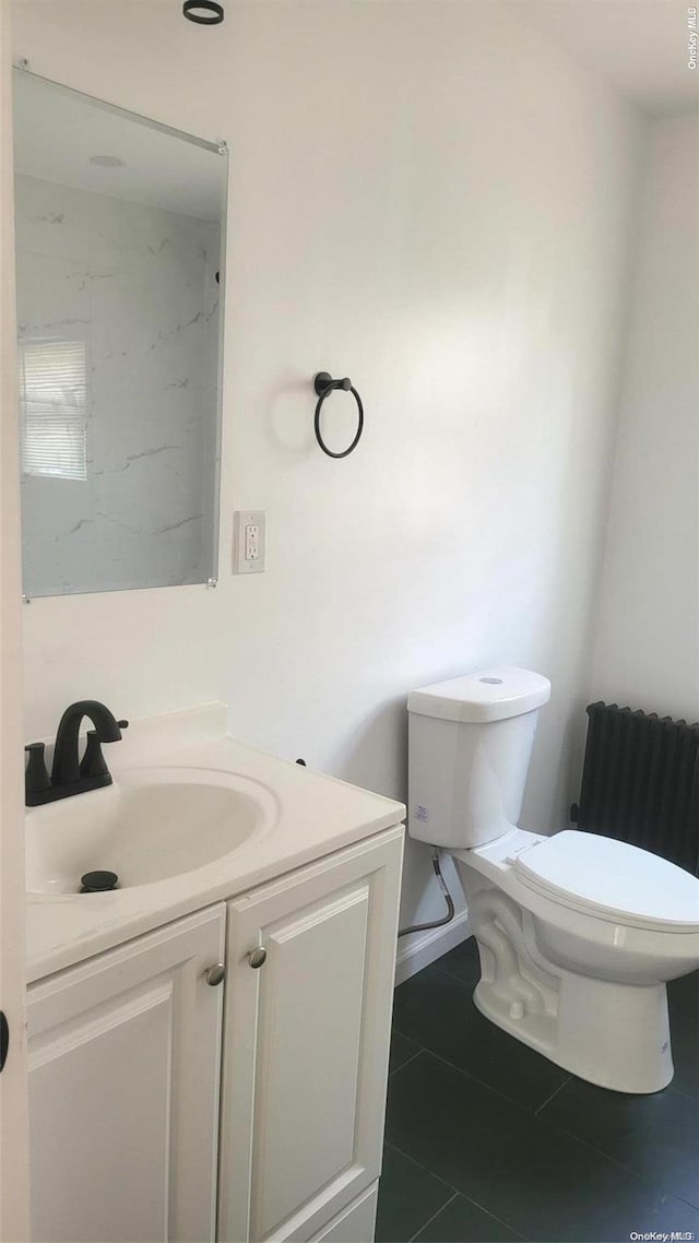 bathroom with radiator, tile patterned flooring, vanity, and toilet