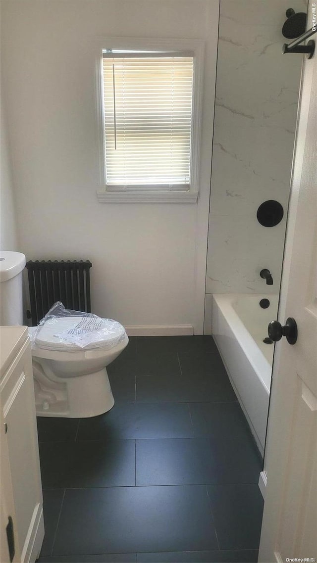 full bathroom featuring vanity, radiator, tile patterned floors, tiled shower / bath, and toilet