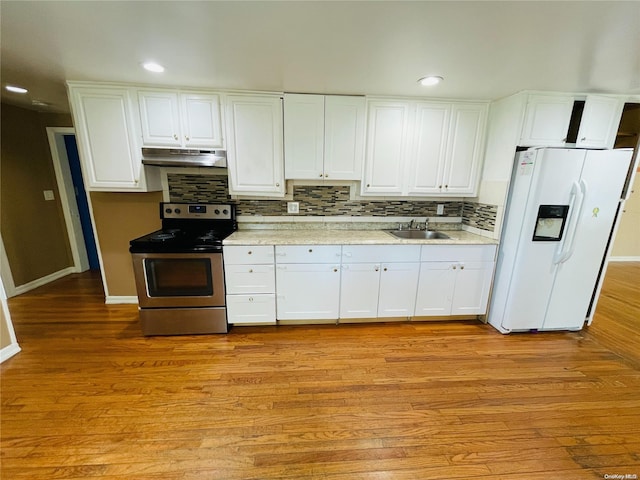 kitchen featuring white cabinetry, white fridge with ice dispenser, stainless steel range with electric cooktop, and light wood-type flooring