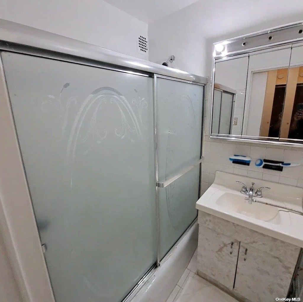 85-15 Main St Unit 12S, Briarwood, NY 11435 - full bath with vanity, enclosed tub / shower combo, and tile patterned floors