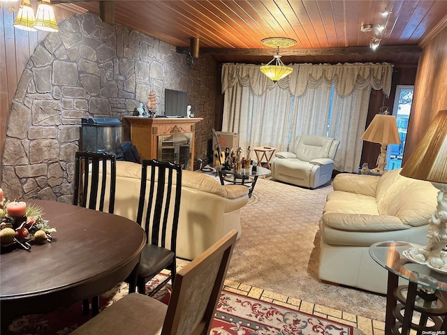 carpeted living room with wooden walls and wooden ceiling