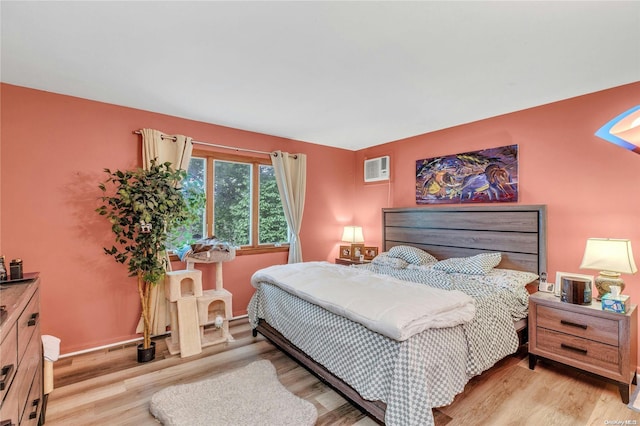 1 Smith St, Glen Head, NY 11545 - bedroom with light wood-style floors and a wall unit AC