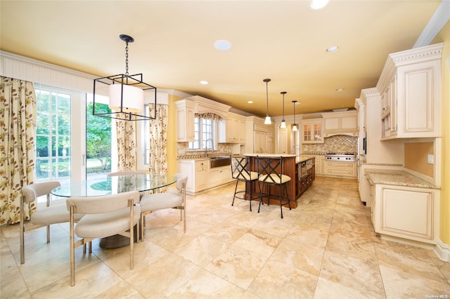 dining space with ornamental molding and sink