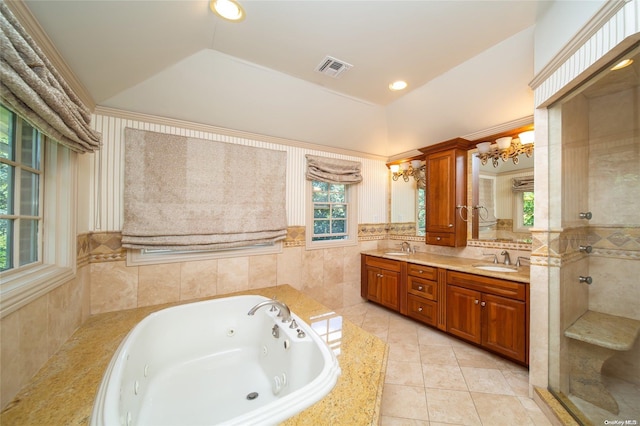 bathroom featuring tile patterned flooring, a notable chandelier, lofted ceiling, vanity, and tile walls