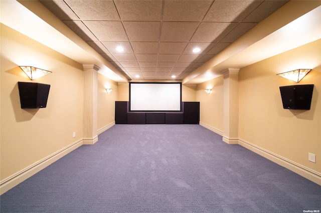 carpeted home theater with a paneled ceiling