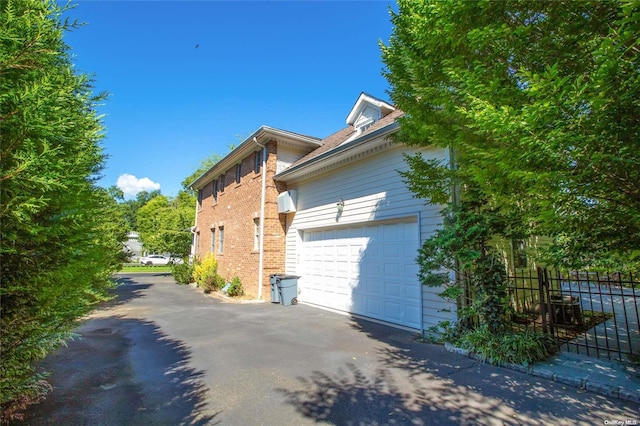 view of side of home featuring a garage