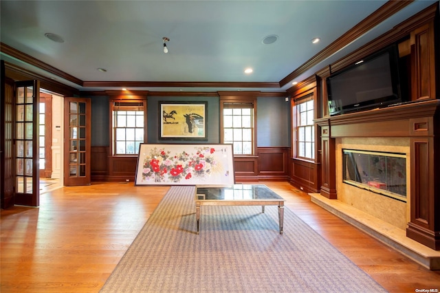 living area with plenty of natural light, french doors, and light hardwood / wood-style flooring