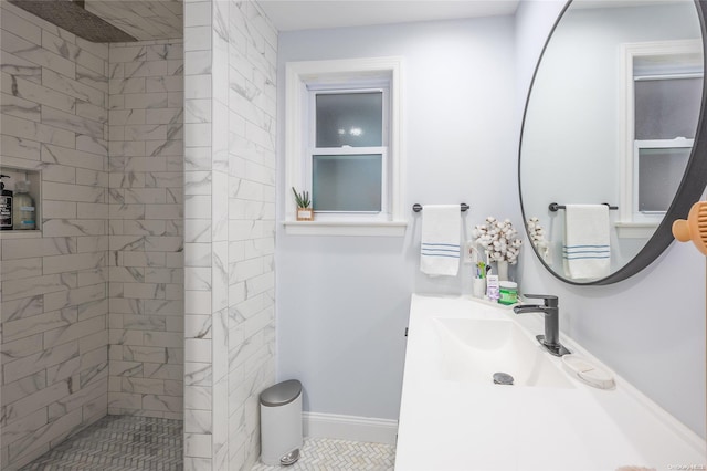 bathroom featuring vanity and tiled shower