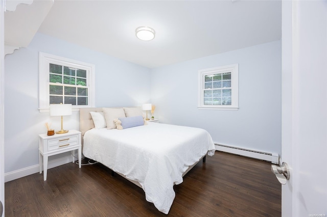 bedroom with dark wood-type flooring and a baseboard radiator