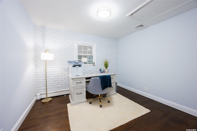 office with baseboard heating, dark wood-type flooring, and brick wall