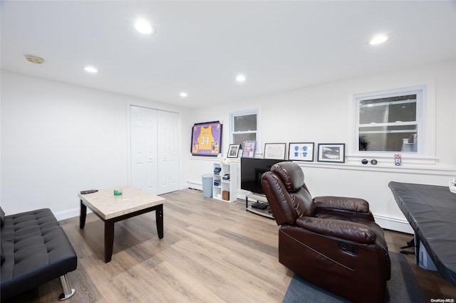 living room featuring baseboard heating and light wood-type flooring