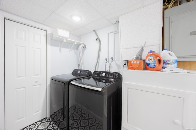 laundry room featuring electric panel and washing machine and clothes dryer