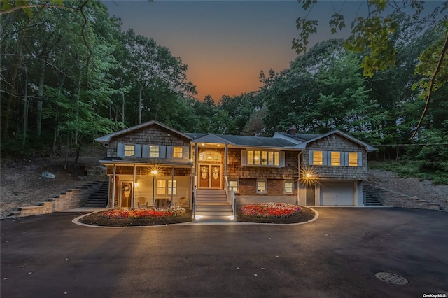 view of front of house featuring a porch and a garage