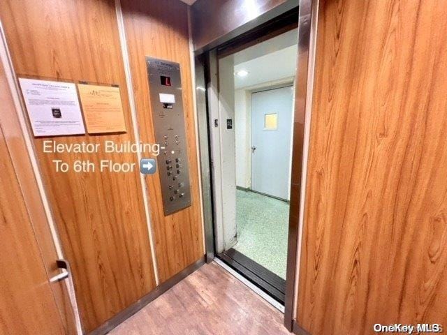 interior space featuring wood walls and hardwood / wood-style flooring