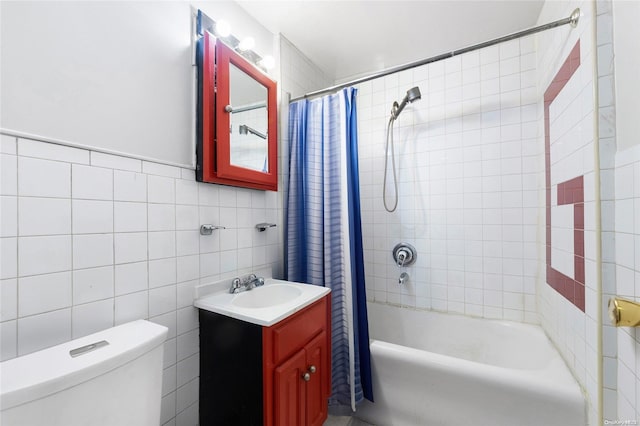 full bathroom with shower / bath combo with shower curtain, vanity, tile walls, and toilet