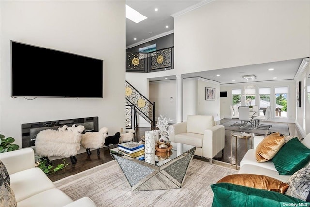 living room featuring crown molding and light wood-type flooring