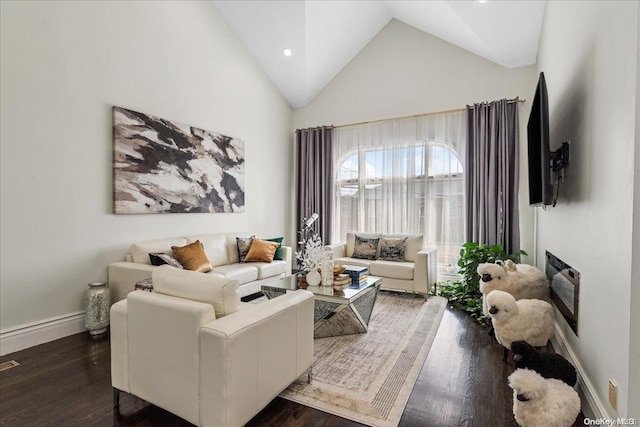 living room featuring dark hardwood / wood-style floors and high vaulted ceiling