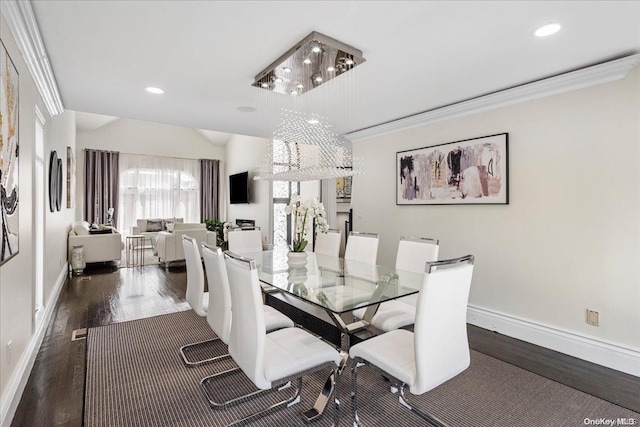 dining area with a notable chandelier, dark hardwood / wood-style flooring, and ornamental molding