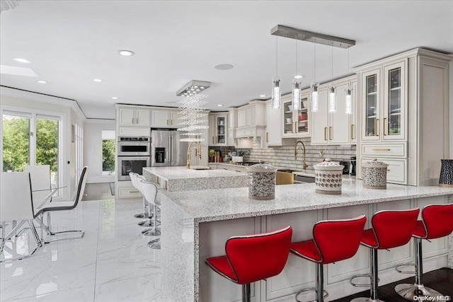 kitchen with appliances with stainless steel finishes, tasteful backsplash, light stone counters, ornamental molding, and decorative light fixtures