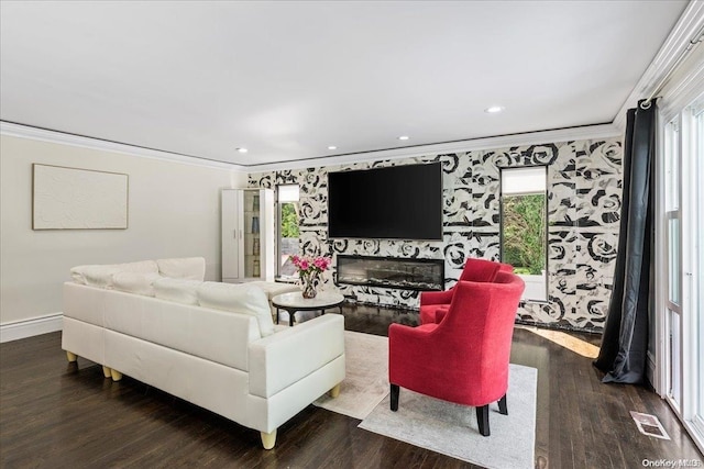 living room with plenty of natural light, dark hardwood / wood-style flooring, and ornamental molding