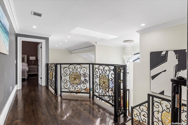 hallway with an inviting chandelier, wood-type flooring, ornamental molding, and a skylight