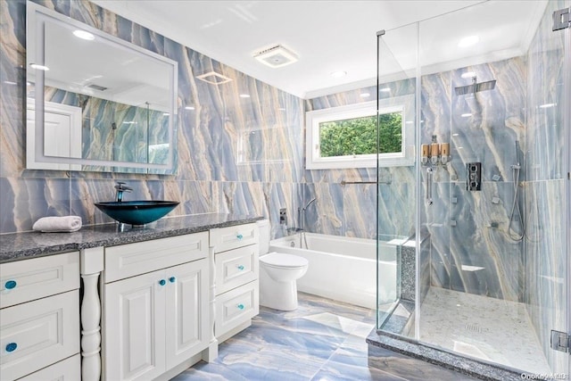 full bathroom featuring vanity, backsplash, toilet, ornamental molding, and tile walls