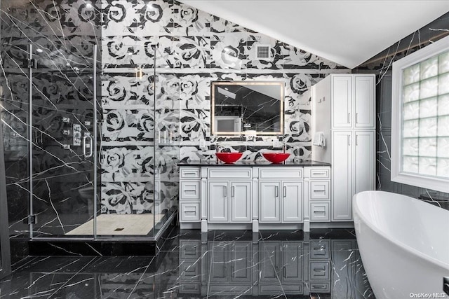 bathroom featuring vanity, lofted ceiling, tile walls, and plus walk in shower