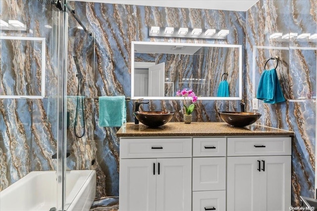 bathroom with vanity and tile walls