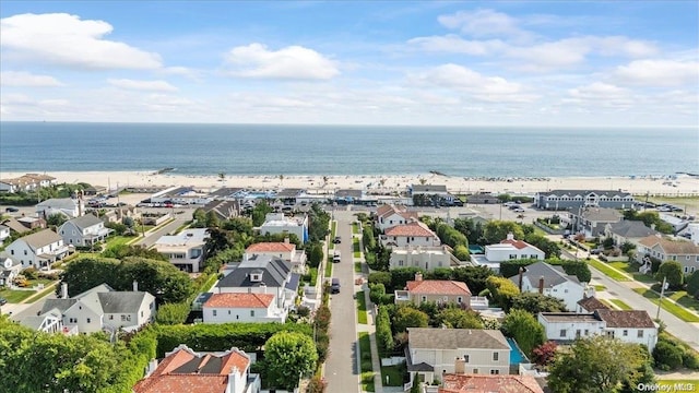 bird's eye view featuring a view of the beach and a water view