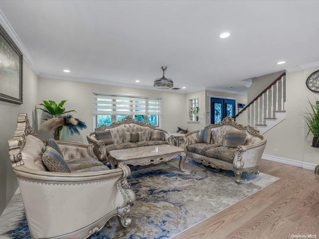 living room featuring hardwood / wood-style floors, french doors, ceiling fan, and ornamental molding