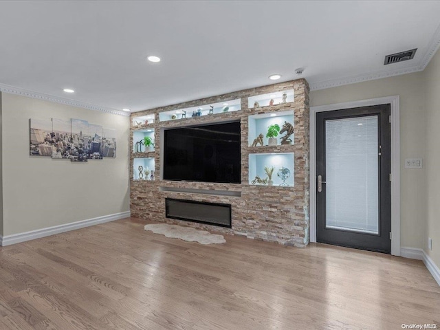 unfurnished living room featuring a fireplace, light hardwood / wood-style flooring, and crown molding