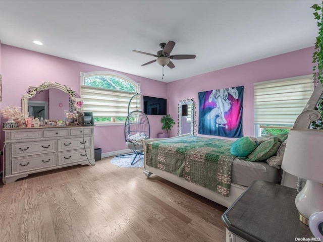 bedroom with ceiling fan and light wood-type flooring