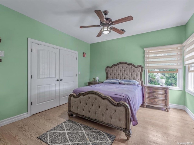 bedroom with ceiling fan, a closet, and light hardwood / wood-style floors