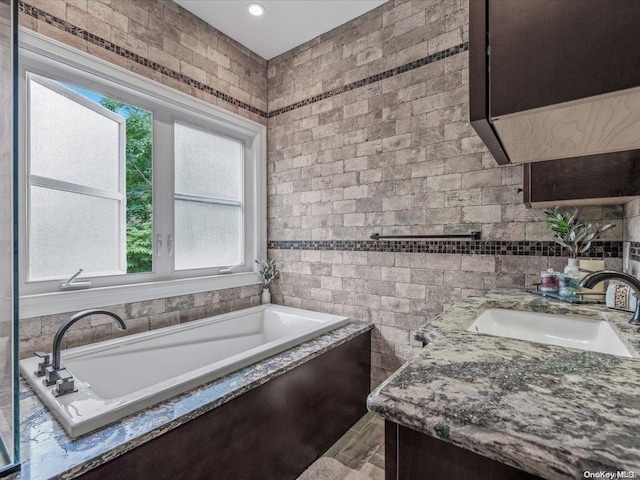 bathroom with a tub to relax in and vanity