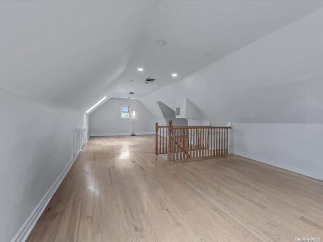 bonus room with light hardwood / wood-style floors and lofted ceiling