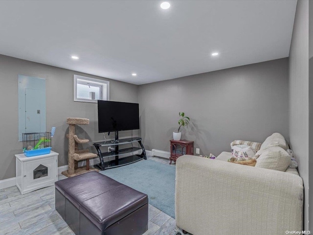 living room with light hardwood / wood-style floors and electric panel