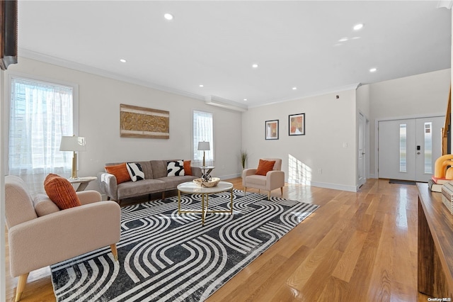 living room featuring light wood-type flooring and crown molding