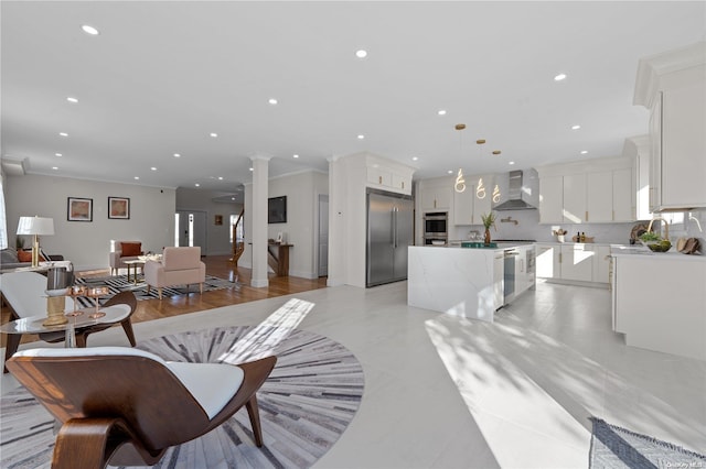 living room featuring sink, light tile patterned floors, and ornamental molding