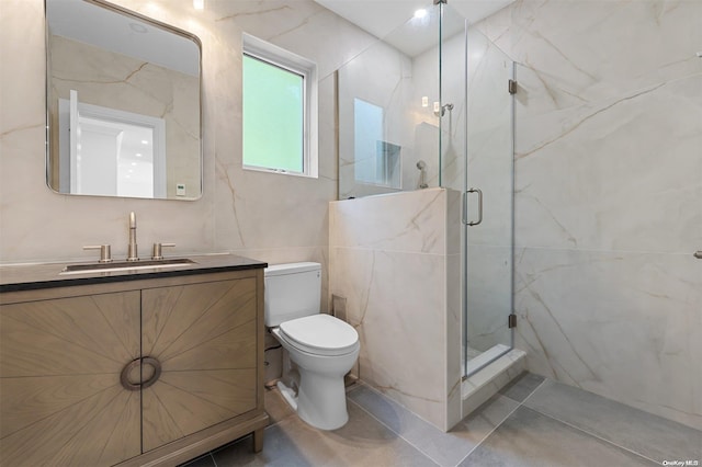 bathroom featuring tile patterned flooring, vanity, toilet, and walk in shower