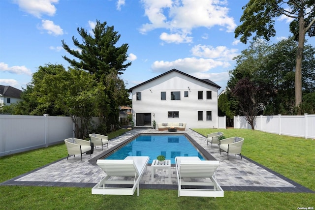 rear view of house with a lawn, a patio area, and outdoor lounge area