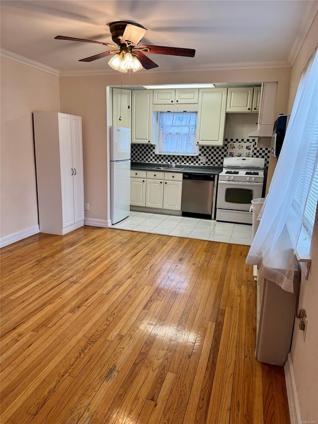 kitchen with white appliances, light hardwood / wood-style flooring, ceiling fan, and backsplash