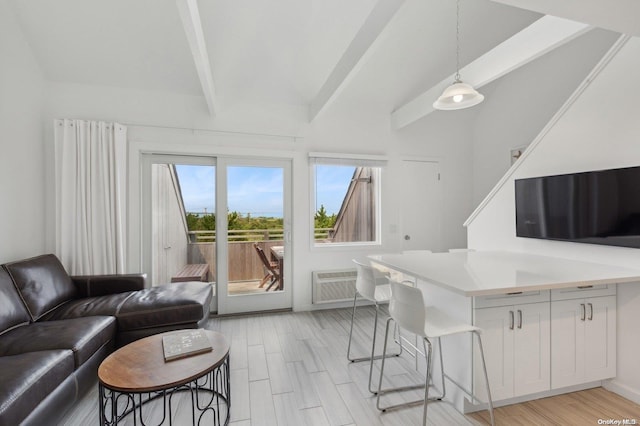 living room with beamed ceiling and light hardwood / wood-style flooring