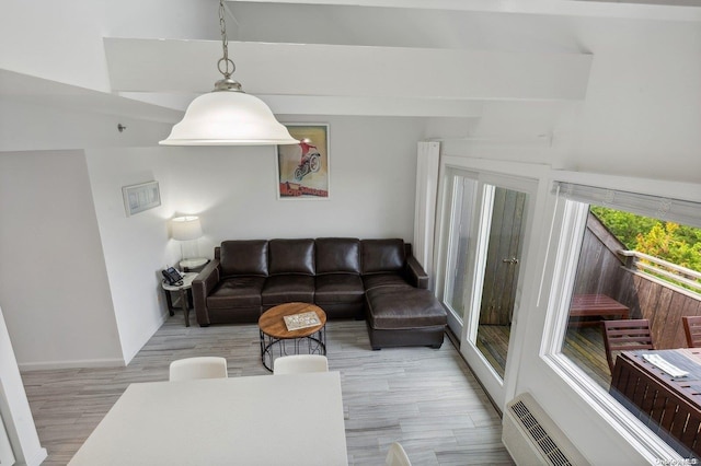 living room with beamed ceiling and light hardwood / wood-style flooring