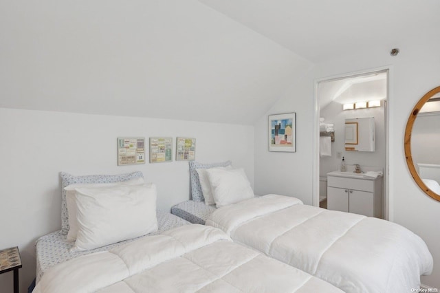 bedroom featuring connected bathroom and vaulted ceiling