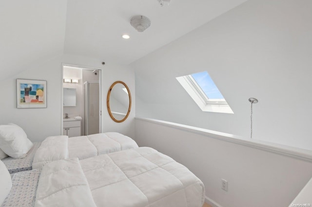 bedroom with lofted ceiling and ensuite bath