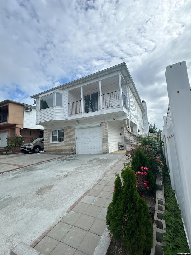 front facade featuring a balcony and a garage