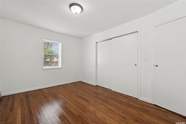 unfurnished bedroom featuring dark wood-type flooring